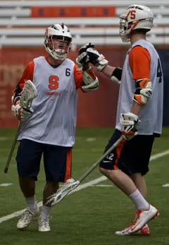 Syracuse attack Pat Powderly and midfielder Chris Kane celebrate together late in the Orange's 16-6 win over Holy Cross.