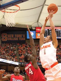 Syracuse point guard Michael Carter-Williams goes up for a layup over St. John's forward Jakarr Sampson.