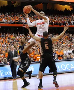 James Southerland leaps to make a mid-air pass Saturday night in SU's loss to Georgetown. The senior forward shot 5-of-14 and 3-of-9 from the arc in a 13-point performance in Saturday night's loss to Georgetown.