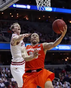Brandon Triche #20 of the Syracuse Orange puts the ball up to the basket against Cody Zeller #40.