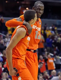 Michael Carter-Williams #1 and Baye Moussa-Keita #12 of the Syracuse Orange celebrate after a win over the Indiana Hoosiers.