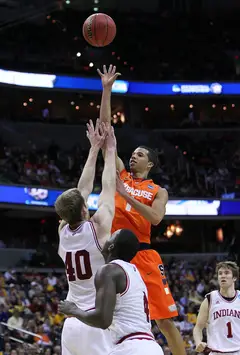 Michael Carter-Williams #1 of the Syracuse Orange shoots the ball over Cody Zeller #40.