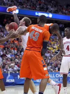 Baye Moussa-Keita #12 of the Syracuse Orange falls in front of teamate James Southerland #43 against Cody Zeller #40.