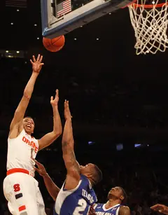Michael Carter-Williams floats a shot over Gene Teague from the baseline.