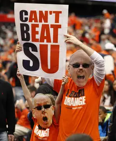 Syracuse fans look to draw the attention of CBS cameras just before tipoff against No. 12 Louisville in the Carrier Dome.