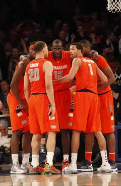 Syracuse, pressured by the close score, regroups and plans their final few plays.