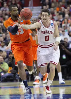 James Southerland #43 of the Syracuse Orange drives down the court against Will Sheehey #0.