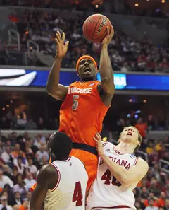 C.J. Fair #5 of the Syracuse Orange puts the ball up to the basket against Cody Zeller #40 and Victor Oladipo #4.