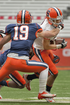 Syracuse cornerback Joe Nassib mirrors an offensive player to attempt a tackle.