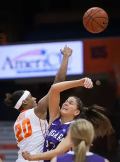 Syracuse's Brittney Sykes (left) battles for the ball against Niagara's Gabby Baldasare (right) during the tipoff.
