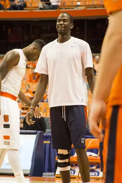 The injured Baye Moussa Keita stands with his team, brace on his knee, before SU's  game against N.C. State. 