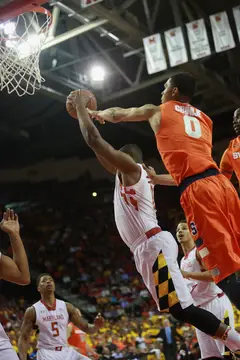 Michael Gbinije challenges a Maryland player in the paint.