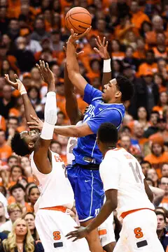 Okafor throws up a shot while Christmas defends with his hands up. The Duke freshman finished with 23 points and 13 rebounds on the night.