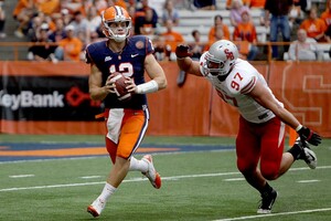 Syracuse quarterback Ryan Nassib rolls out and looks to make a pass downfield Saturday. Nassib finished with 335 yards passing and three touchdown's in the Orange's 28-17 win over Stony Brook.