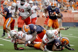 Syracuse linebacker Dyshawn Davis tackles Stony Brook running back Miguel Maysonet in the Orange's 28-17 win on Saturday. After some mid-game defensive adjustments, SU shut down the Seawolves' running game in the second half. 