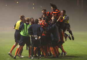 The Syracuse men's soccer team celebrates its 2-1 overtime win over Rutgers on Wednesday night. The team won its ninth game of the season, its most since 1999.