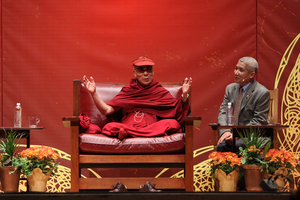 The Dalai Lama speaks during the panel discussions on Monday.