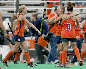 Jordan Page (3) celebrates with teammates Iona Holloway (8) and Anna Crumb during Syracuse's 3-2 win over Connecticut for the Big East regular-season championship on Saturday. It was the team's third title in four years.
