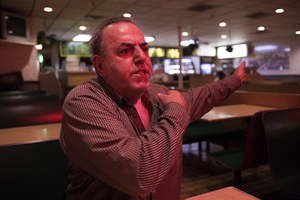 Peter Mavrikidis, owner of Acropolis Pizza House on Marshall Street, gestures toward his restaurant while speaking about the establishment’s upcoming nuisance abatement hearing. The restaurant is increasing security measures to avoid being shut down by the city.