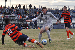 Syracuse defender Tyler Hilliard tries to get the ball from Georgetown's Jimmy Nealis while midfielder Ted Cribley looks on. SU lost the third-round tournament game on penalty kicks.
