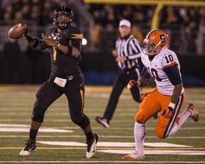 Missouri quarterback James Franklin goes to pass while Syracuse defensive end Markus Pierce-Brewster chases. Franklin left the game in the third quarter due to injury. 