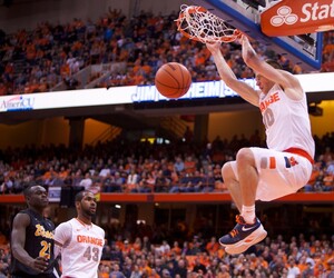 Syracuse University Guard Trevor Cooney finishes an emphatic breakaway dunk during the Orange's rout of Long Beach State Thursday Night at the Carrier Dome. Cooney made 4 of 9 shots for 11 points in the Syracuse victory.