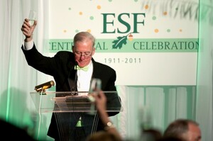 SUNY-ESF President Cornelius Murphy lifts his glass in a toast to celebrate the university's 100th anniversary in August 2011.
