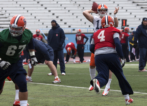 Brandon Reddish (4) pressures quarterback Ryan Nassib in practice Thursday as Syracuse prepares to slow West Virginia quarterback Geno Smith and the Mountaineers' high-powered aerial attack.