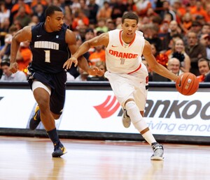 Syracuse guard Michael Carter-Williams dribbles past Monmouth's Dion Nesmith in the Orange's 108-56 win over the Hawks on Saturday. Carter-Williams finished with 16 assists.