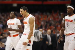 Michael Carter-Williams celebrates his game-tying 3 with 1:21 left in the game against Cincinnati Monday. His shot tied the score at 55-55, and the Orange went on to finish the comeback winning 57-55