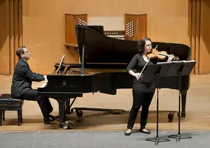 Donald Berman and Gabriela Diaz, the pianist and violinist of Dinosaur Annex, respectively, perform at the Setnor Music Hall in front of a crowd of community members and students. Dinosaur Annex is a group of chamber musicians who embrace a futuristic sound. 