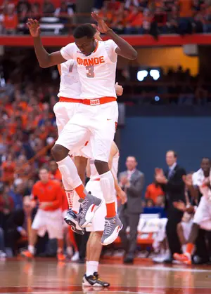 Jerami Grant jumps for joy with sophomore point guard Michael Carter-Williams. Grant filled in for the ineligible James Southerland with 13 points in 29 minutes, both season highs.