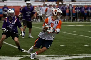 JoJo Marasco cradles the ball against Holy Cross. The senior midfielder featured all over the field for the Orange, sending his team to a pair of scrimmage wins Saturday afternoon. He tallied one goal and five assists on the day.