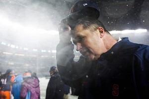 Doug Marrone removes his hat as he walks toward the end zone following Syracuse's Pinstripe Bowl victory Dec. 29.