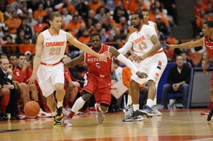 Syracuse guard Brandon Triche dribbles away from Rutgers guard Eli Carter in the Orange's 78-53 win over the Scarlet Knights on Wednesday in the Carrier Dome. Triche finished with a game-high 25 points.