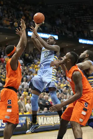 C.J. Fair contests a shot from Marquette forward Jamil Wilson in Syracuse's 74-71 loss to Marquette on Monday. Fair scored 20 points for the Orange, but had limited scoring opportunities in the second half. 