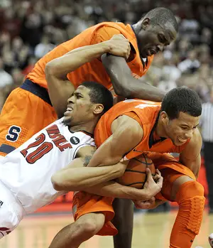 Michael Carter-Williams fights for the ball with Louisville's Wayne Blackshear in Syracuse's 70-68 win over the Cardinals back on Jan. 19. The Orange and Louisville will have a rematch Saturday in the Carrier Dome.