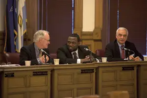 Bob Dougherty, Khalid Bey and Nader Maroun, Syracuse Common Councilors converse at Monday’s meeting. The resolution to amend city zoning codes was held.
