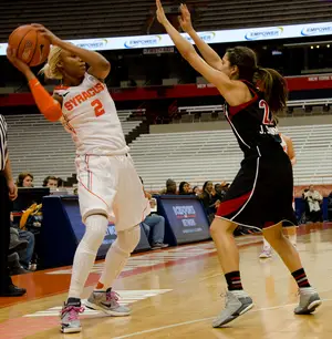 Syracuse guard Elashier Hall looks to pass around a defender. Hall scored 10 points in the Orange's regular-season finale.