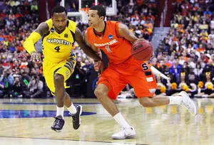 Point guard Michael Carter-Williams drives past guard Todd Mayo in Syracuse's Elite Eight victory over Marquette.