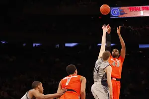 James Southerland takes a shot over Georgetown forward Nate Lubick in Syracuse's 58-55 win over the Hoyas on Friday. Southerland tied a Big East tournament record with 16 made 3-pointers in the tournament. 