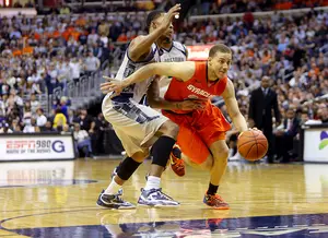 Brandon Triche dribbles the ball during Syracuse's 61-39 loss to  Georgetown on Saturday. Triche scored only two points on 1-of-9 shooting.