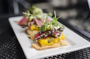 Small Plates menu provides a wide array of smaller portioned options including Caesar salad, fish tacos and the lotus flower tuna, a seared sesame crusted tuna served on a fried wonton and mango avocado salad dressed with a wasabi aioli and a miso vinagrette.  