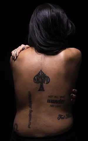 Jess Laurello, a  senior advertising major, has eight tattoos, all with different styles of typography. Her most recent tattoo was a Lewis Caroll quote in the shape of a spade.