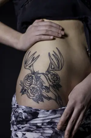 Haley Tyminski has three tattoos, one of which, a deer’s skull framed by roses, is located on her hip. 