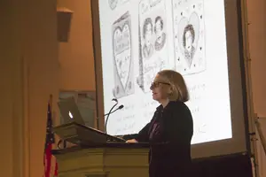 Roz Chast shows and describes one of her cartoons at Hendricks Chapel Wednesday night. 