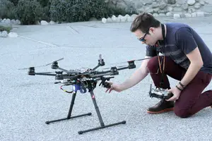 Arland Whitfield examines one of his drones, which is part of his fleet of three machines. 