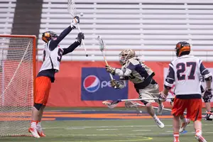 Senior goalie Dominic Lamolinara makes a save in Syracuse's 11-10 win over Notre Dame on Saturday. Lamolinara was relieved at halftime by junior Bobby Wardwell, and each goalie was great in the victory. 