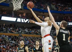 Tyler Ennis finishes a layup against Western Michigan in the second round of the NCAA Tournament. On Thursday, the  freshman announced his decision to enter his name in the NBA Draft and forgo his remaining three years of college eligibility. 