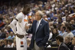 SU head coach Jim Boeheim (right) and center Baye Moussa Keita (left) talk by the Syracuse bench in the Orange's loss to N.C. State on Friday night. 